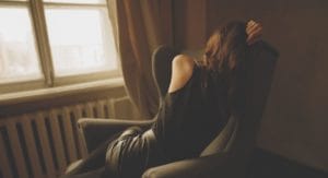 women with his head in his hands is in need of depression treatment programs